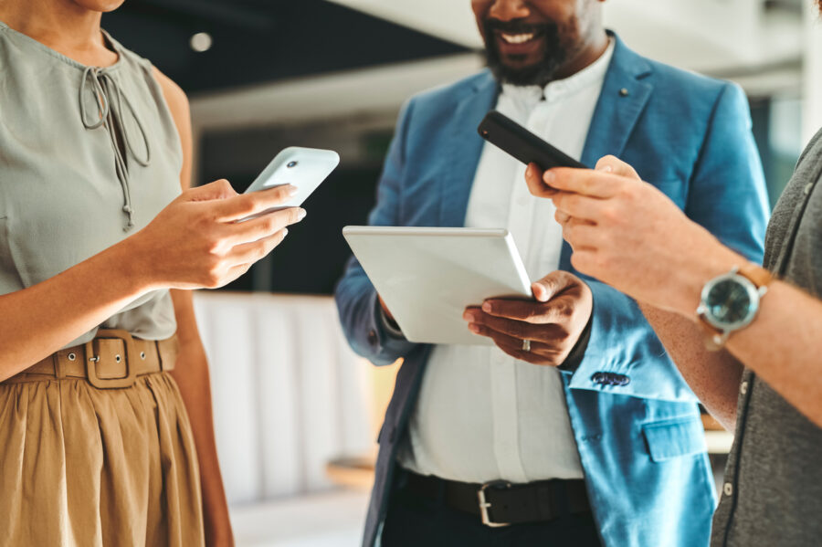 Diversity In Working Team Using Internet On Phones And Digital Tablet For Teamwork Growth In The Office. Professional Staff Work With 5g Technology To Match Work Schedule Online The Company Website