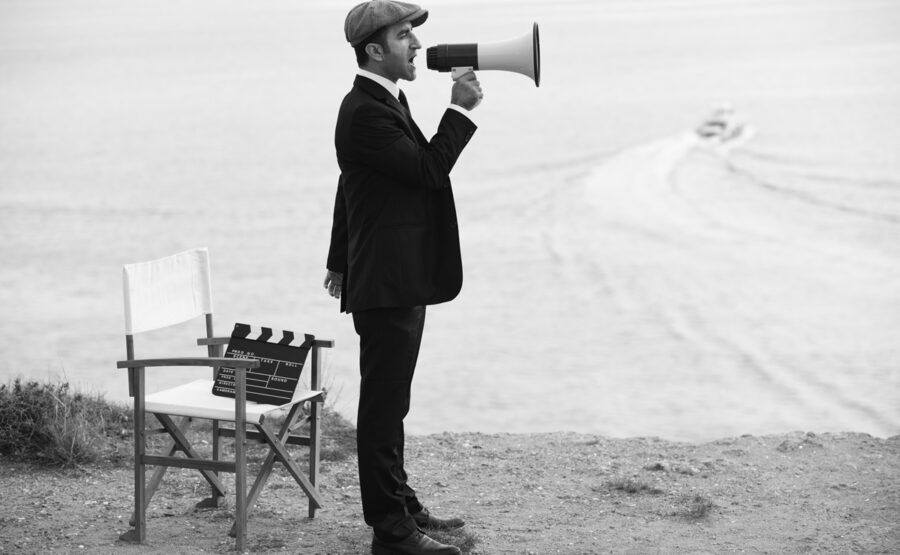 Mid Adult Man Directing Film In Outdoor Movie Set