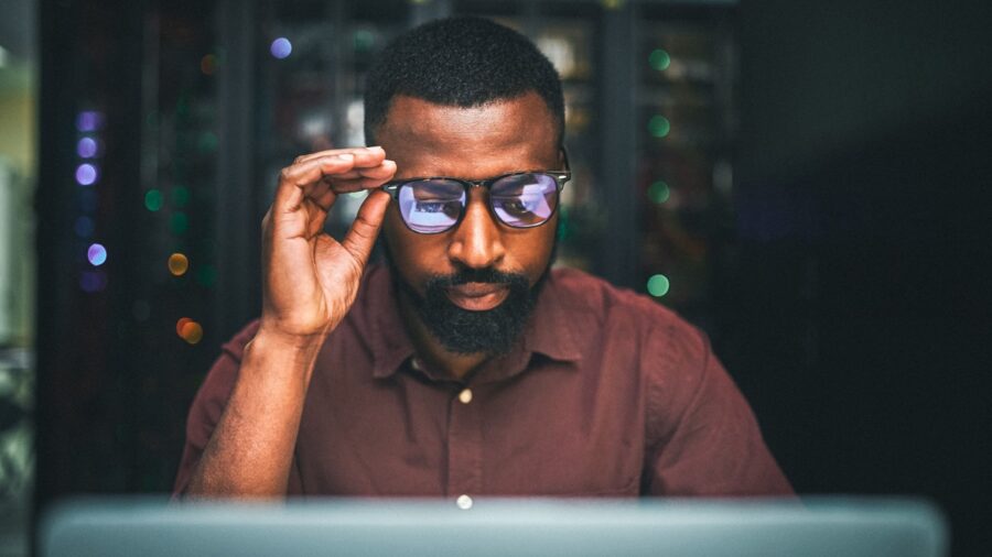 Shot Of An Male It Technician In A Server Room And Using A Laptop