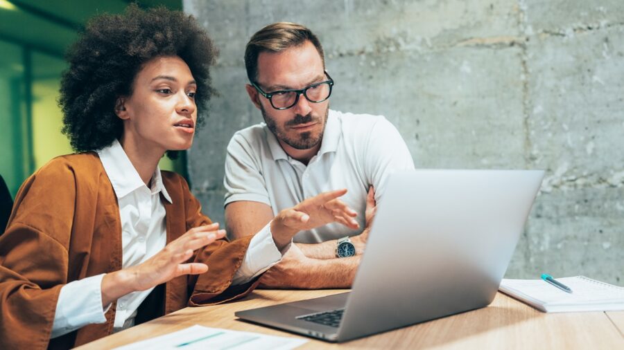 Two Business People Working Together In Office