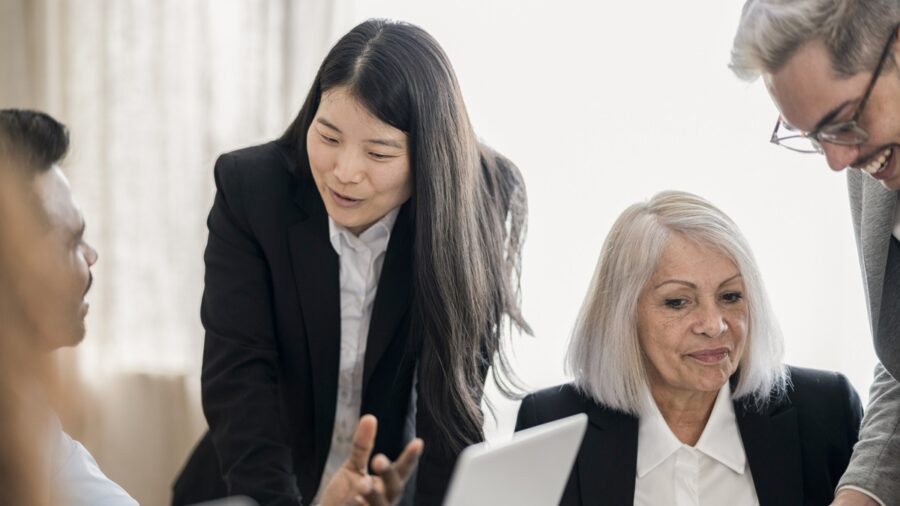 Intergenerational Team Engaged In Lively Business Discussion